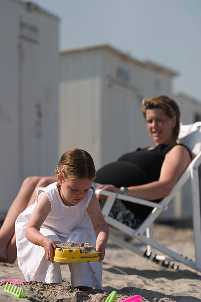 istock mother and daughter on the beach 91101471