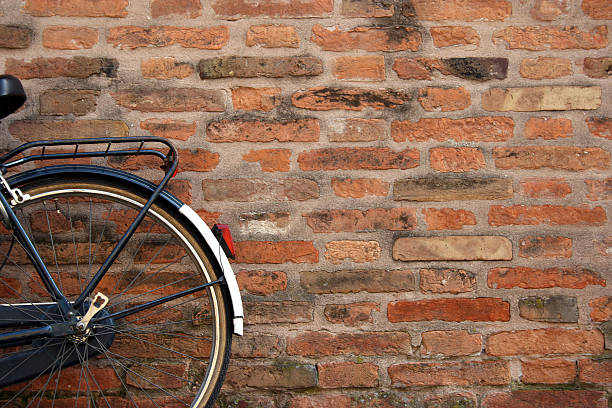 Kids bicycle standing with a brick wall