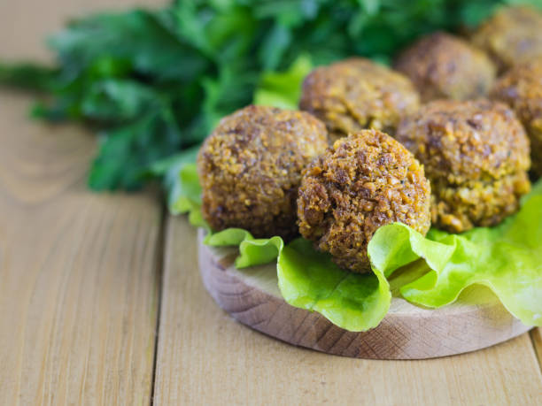 istock Classic freshly made falafel on a salad leaf on a cutting Board. 911014866