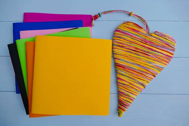 istock Colorful notebooks and a colorful heart lying on right side 911015464