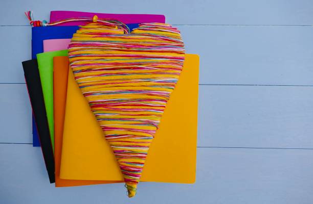 istock Colorful notebooks and a colorful heart lying on top 911015500