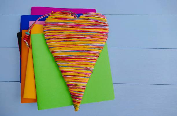 istock Colorful notebooks and a colorful heart lying on top 911015578