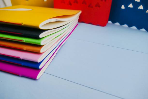 istock Colorful notebooks and abstract hearts in background 911015814