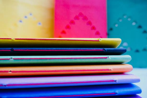 istock Colorful notebooks and abstract hearts in background 911015870