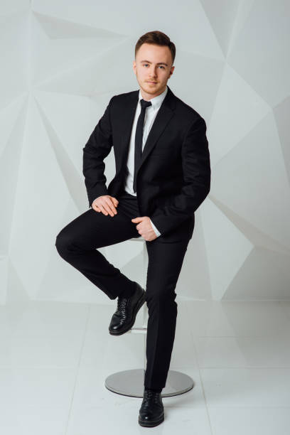 istock young business man in modern suit sitting on chair 911015948