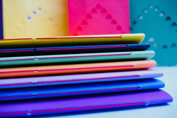 istock Colorful notebooks and abstract hearts in background 911016088