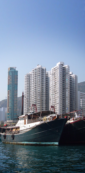 A Panoramic view of Hong Kong Harbour with trawler boats right in front of the high rise apartments in Aberdeen village. Don't go for the sampan ride here - you'll get overcharged.