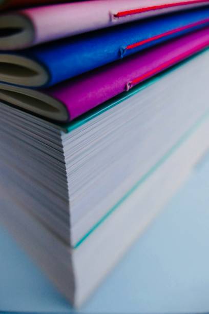 istock Colorful notebooks lying on thick books 911022492