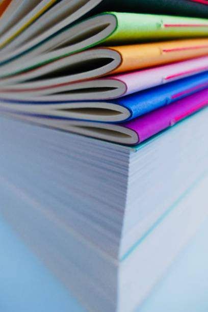 istock Colorful notebooks lying on thick books 911022596