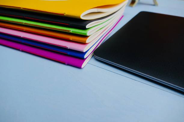 istock Colorful paper notebooks and a laptop, 911022644