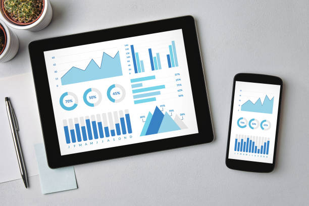 Graphs and charts elements on tablet and smartphone screen Graphs and charts elements on tablet and smartphone screen over gray table. All screen content is designed by me. Flat lay gray chart stock pictures, royalty-free photos & images