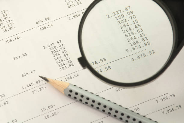 istock Financial results concept. Magnifier and pencil on a numbers background 911029596