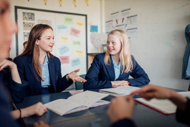 Discussion During Class Point of view angle of teenage girls taking in class. teenage high school girl raising hand during class stock pictures, royalty-free photos & images