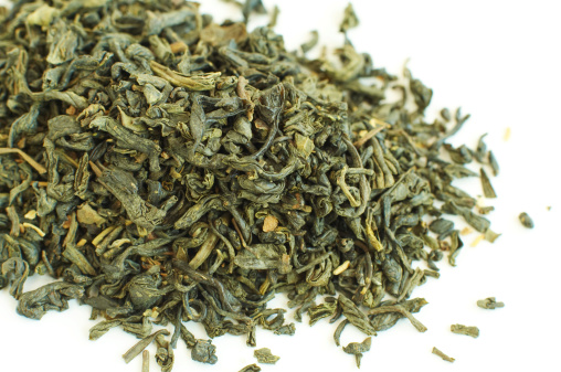 dry green tea on white background