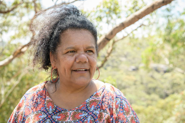 Headshot of mature Australian woman with hair up outdoors