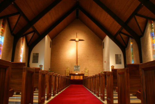 The inside view of a church with pews on either side
