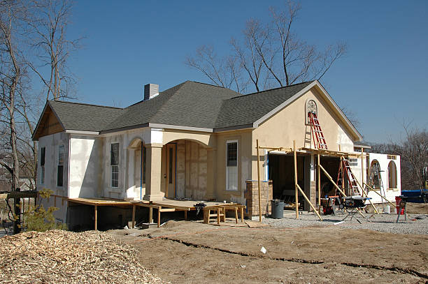 House under construction against blue sky Home Additions and ADUs .