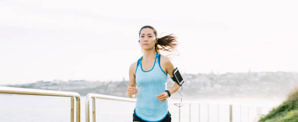 istock Young Asian Woman Running 911037202