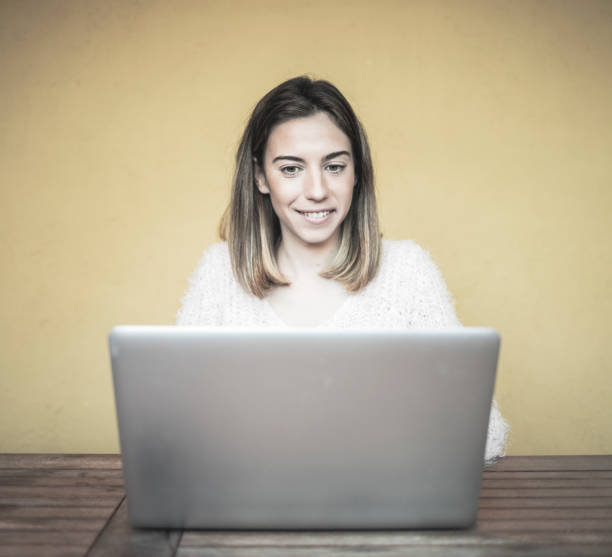 istock Woman using laptop at home 911039010