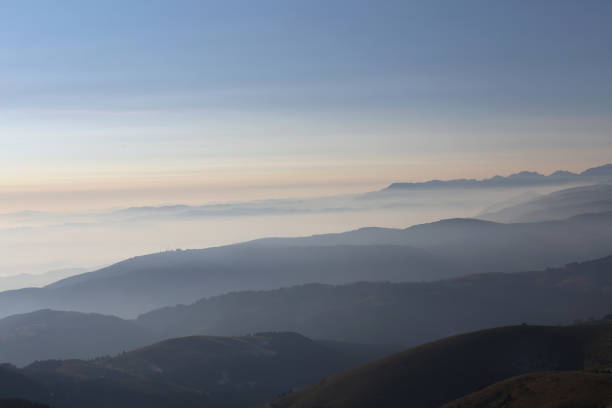 istock Mountains at sunrise surrounded by fog 911039024