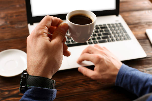 istock Casually dressed student / blogger / writer / man working on pc laptop, typing on keyboard, writing blog article, drinking in coffee shop / bar, using smartphone. Top view of workspace office desk. 911046236