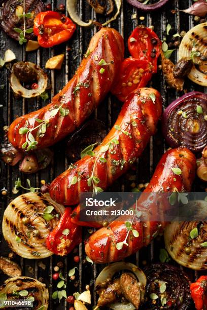 Grilled Sausages And Vegetables With Addition Spices And Fresh Herbs Stock Photo - Download Image Now