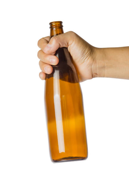 istock Woman's hand holding empty beer bottle transparent on white background 911046730
