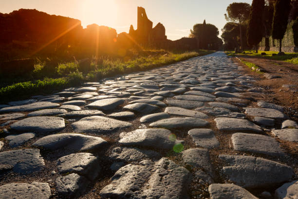 Appian Way Roma, italy - October 23, Stones of the road said Basolato at sunset ancient rome stock pictures, royalty-free photos & images