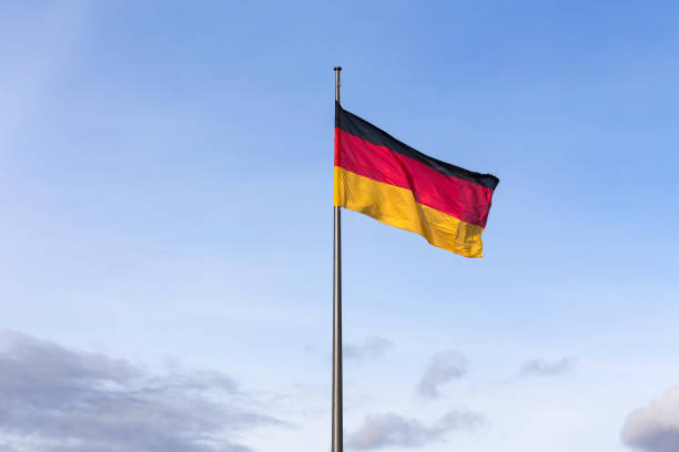 istock big german flag in front of a blue sky 911050004