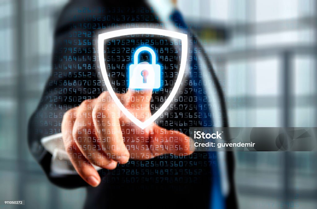 Security Concept Person touching shield with lock Network Security Stock Photo