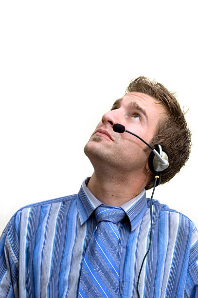 businessman with headset looking up stock photo