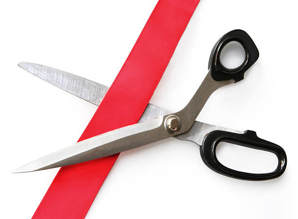 istock Pair of scissors cutting red tape 91105170