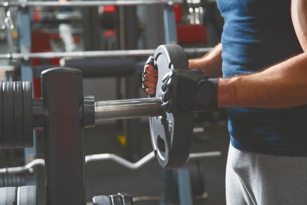 istock Strong male bodybuilder with barbell pancakes 911056198
