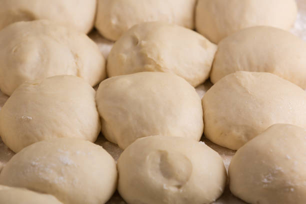 istock Ball-shaped pieces of dough prepared for baking pies 911061334