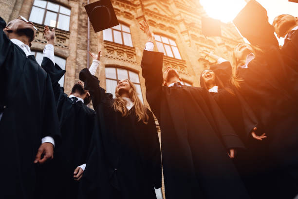 istock Graduates of the university toss their caps up. 911101108