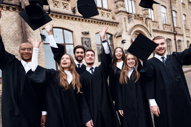 istock Graduates of the university toss their caps up. 911101124