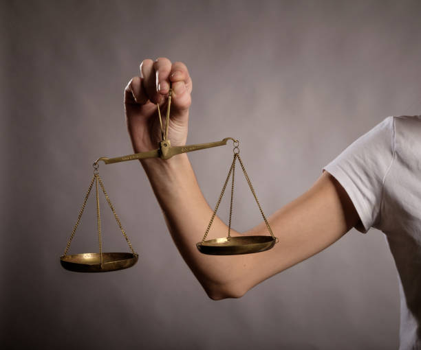 istock young woman holding a justice scale 911119276