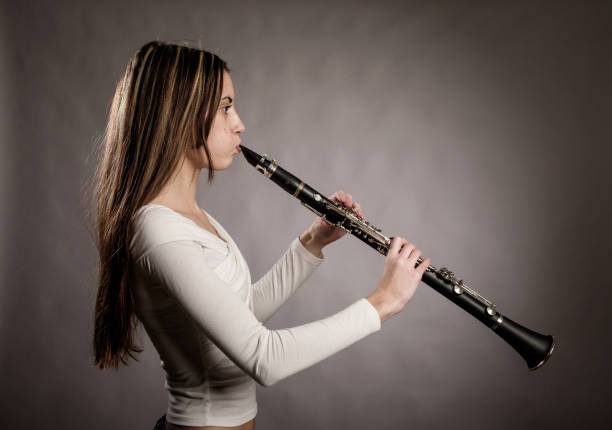 istock young woman playing a clarinet 911119298