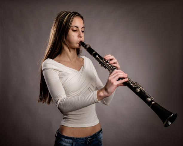 istock young woman playing a clarinet 911119302