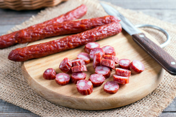 istock Smoked sausages on a cutting board on a wooden table 911127844