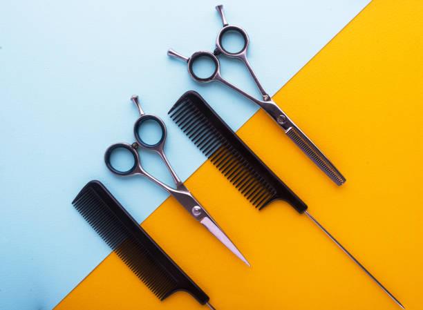 istock combs and hairdresser tools on color cardboard background top view 911128244