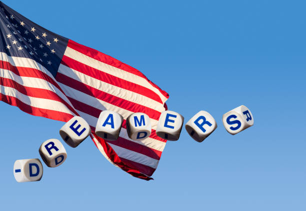 istock Dreamers concept using spelling letters against blue sky and flag 911138796