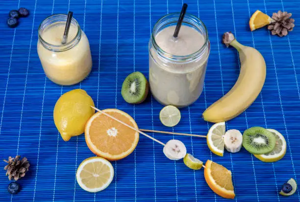 healthy and delicious fruit smothie with kiwi, orange banana, and lemon