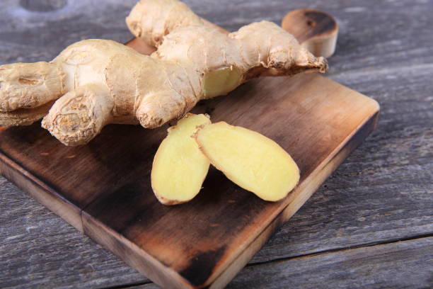 istock Fresh ginger whole and chopped on wooden cutting board 911149798