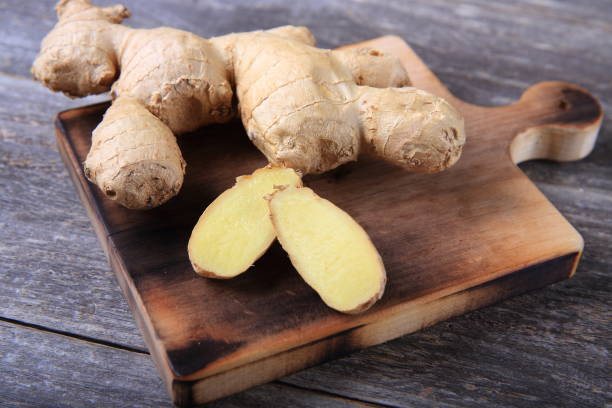 istock Fresh ginger whole and chopped on wooden cutting board 911149804