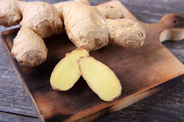 istock Fresh ginger whole and chopped on wooden cutting board 911149862