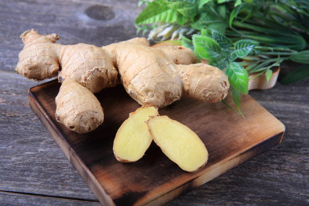 istock Fresh ginger whole and chopped on wooden cutting board 911149894