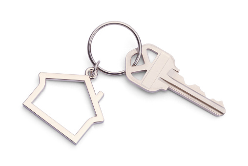 House Key With House Keychain Isolated on a White Background.