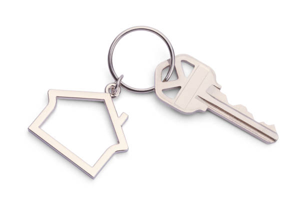 Real Estate Key House Key With House Keychain Isolated on a White Background. house key stock pictures, royalty-free photos & images