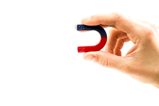 istock Magnet in female hand on a white background 911174898